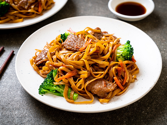 A bowl of pork noodle stir fry